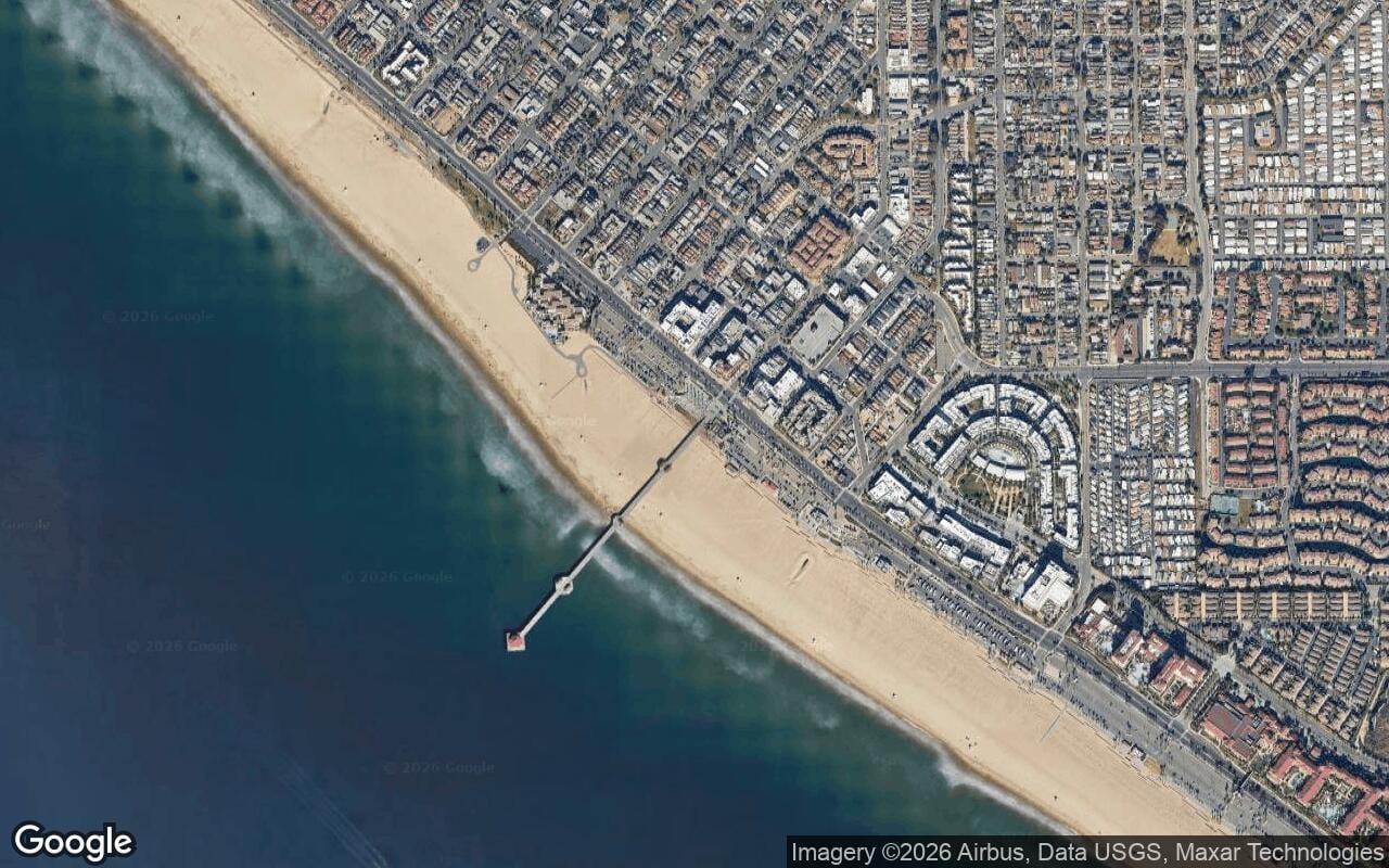 Aerial view of streets and coastline around the Downtown Pier District in Huntington Beach.